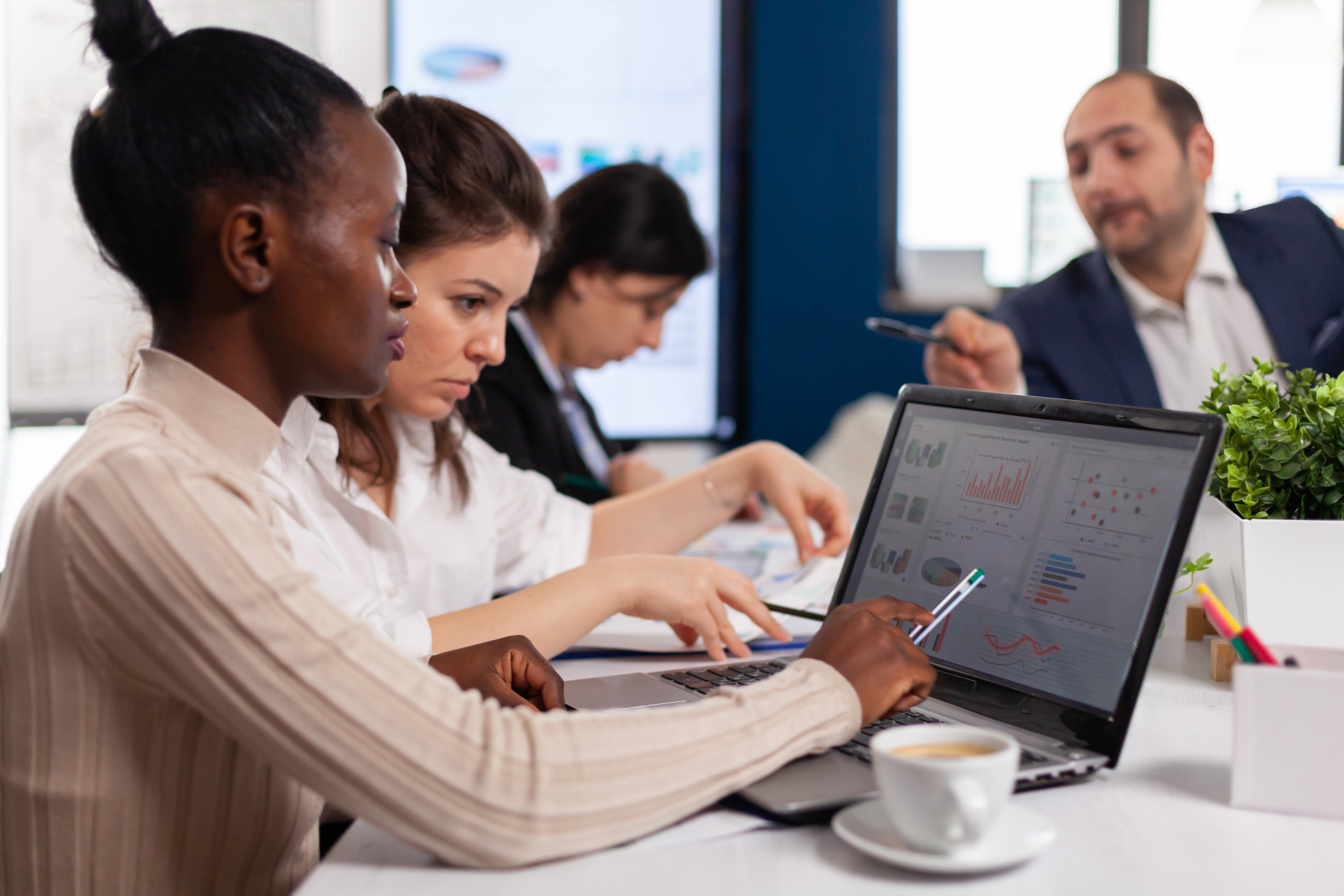 A group of executives review the policy and benefits in their compensation package.